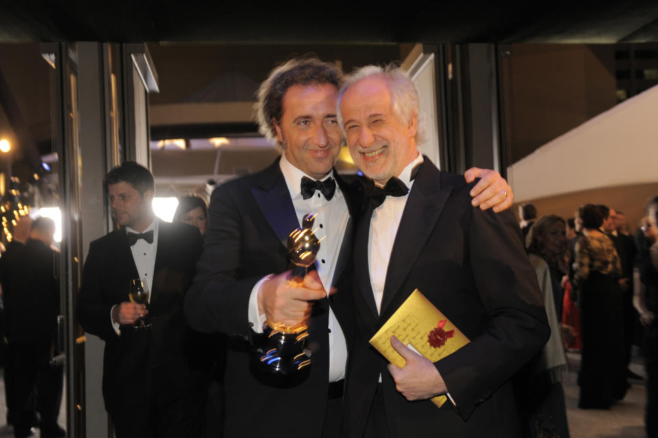 Paolo Sorrentino, left, poses with the award for best foreign language film of the year for "The Great Beauty" with Toni Servillo at the Governors Ball after the Oscars on Sunday, March 2, 2014, at the Dolby Theatre in Los Angeles. (Photo by Chris Pizzello/Invision/AP)