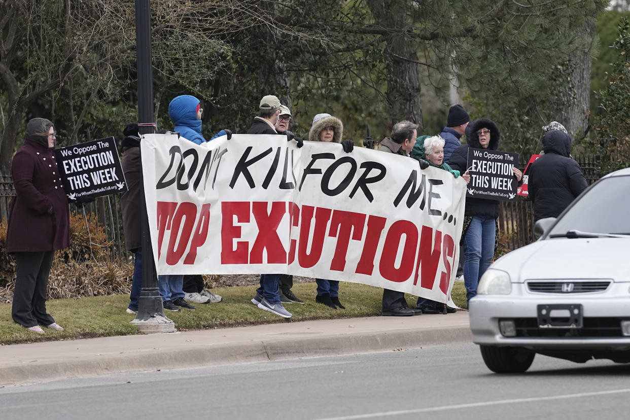 Death penalty opponents protest on the street outside the Governor's mansion, Thursday, Jan. 12, 2023, in Oklahoma City. Oklahoma executed a Scott James Eizember, 62, who was convicted of killing an elderly couple and committing other crimes 20 years ago before authorities caught up to him in Texas after a manhunt. (AP Photo/Sue Ogrocki)