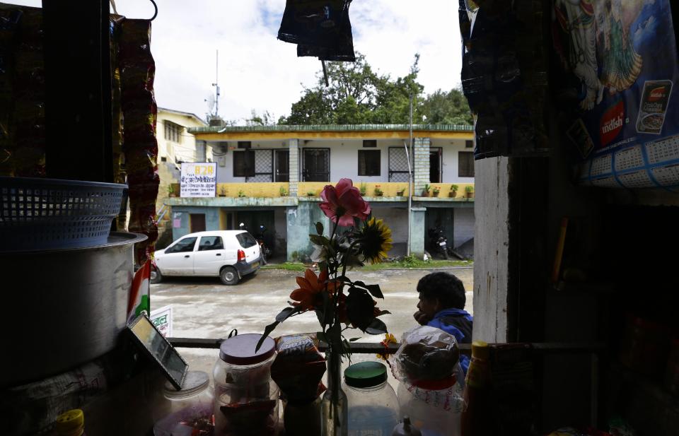 This Aug. 23, 2012 photo shows the B2R offices across the street from a new eatery that has sprung up to cater to its employees in Simayal, India. While workers in the Delhi suburbs make about 8,000 rupees (US$160) a month, B2R's start at about 4,700 rupees (US$95). The company's CEO said the lower salary is justified by the lower cost of living here, and many workers say they are still saving significant portions of their salary. (AP Photo/Saurabh Das)