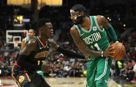 Nov 18, 2017; Atlanta, GA, USA; Boston Celtics guard Kyrie Irving (11) moves against Atlanta Hawks guard Dennis Schroder (17) in the fourth quarter at Philips Arena. Mandatory Credit: Jason Getz-USA TODAY Sports