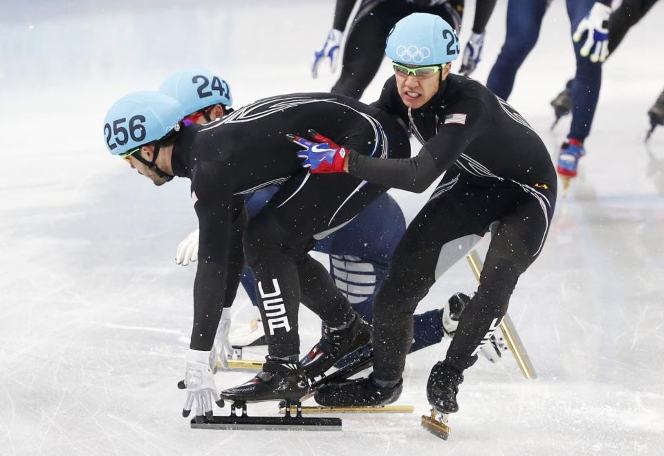 Skaters of the U.S. try to recompose after crashing during the men's 5,000 metres short track speed skating relay semi-final event at the Iceberg Skating Palace during the 2014 Sochi Winter Olympics February 13, 2014. REUTERS/Lucy Nicholson (RUSSIA - Tags: SPORT SPEED SKATING OLYMPICS)