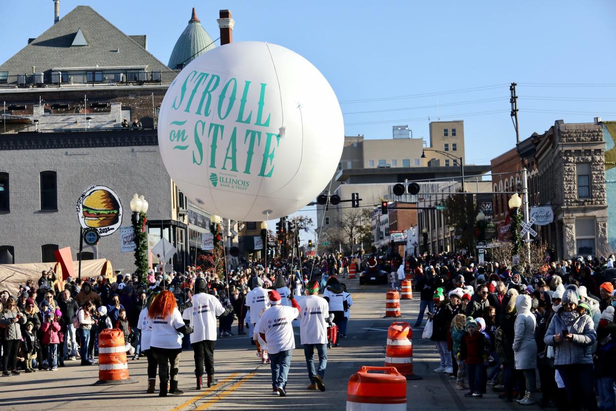 Participants walk in the Stroll on State parade Saturday, Nov. 27, 2021, in downtown Rockford. The annual event returns to Rockford Saturday, Nov. 26, 2022.