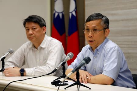 Taiwan's Ministry of Health and Welfare's, Office of International Cooperation director, Hsu Ming-hui (R), talks during a news conference on how Taiwan would react if it is not invited to the World Health Assembly (WHA), in Taipei, Taiwan May 8, 2017. REUTERS/Tyrone Siu