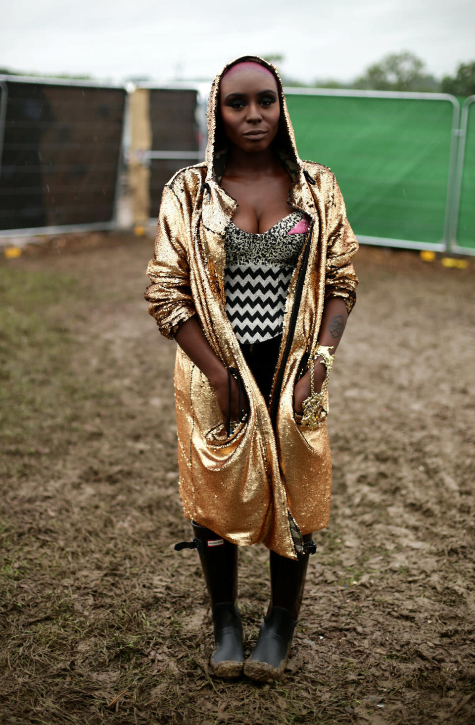 Singer Laura Mvula made a statement in a glitzy gold caped jacket and a mixed print top. 