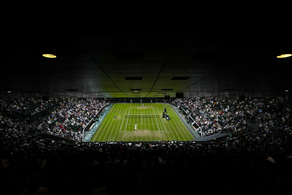 Tim van Rijthoven of the Netherlands returns the ball to Serbia's Novak Djokovic during a men's fourth round singles match on day seven of the Wimbledon tennis championships in London, Sunday, July 3, 2022.(AP Photo/Alastair Grant)