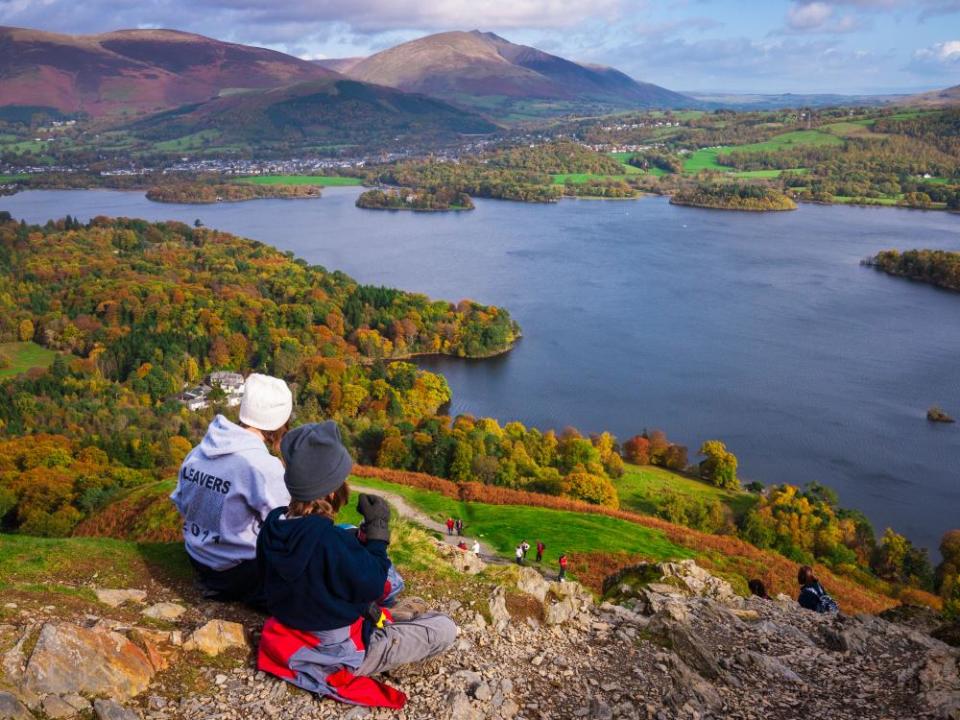 Teenage brother and sister enjoying the view over Derwent Water from Catbells