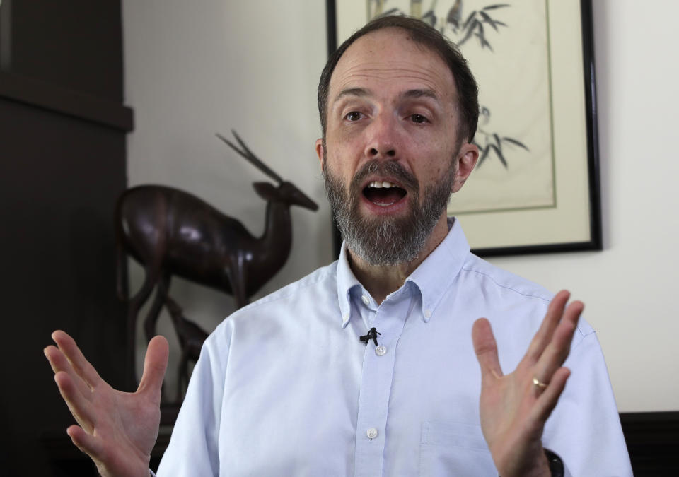 In this Jan. 30, 2019 photo, Dr. Rick Sacra speaks to the Associated Press at his home in Holden, Mass. Sacra, a Massachusetts doctor who was among a handful of Americans treated and cured of Ebola in 2014, is being honored for his work in Liberia through the deadly epidemic. (AP Photo/Elise Amendola)