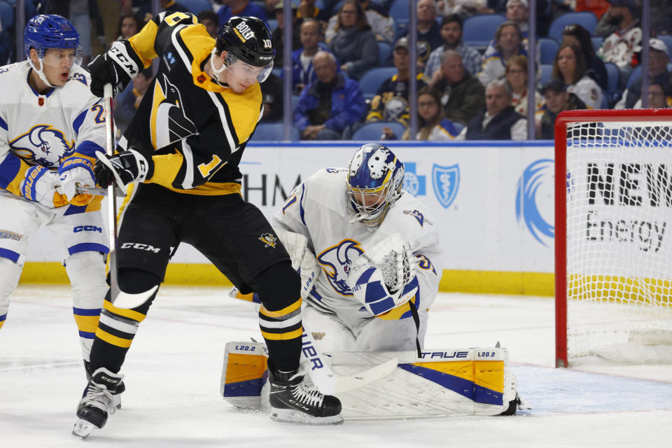 Buffalo Sabres goaltender Eric Comrie (31) stops Pittsburgh Penguins left wing Drew O'Connor (10) during the second period of an NHL hockey game Wednesday, Nov. 2, 2022, in Buffalo, N.Y. (AP Photo/Jeffrey T. Barnes)