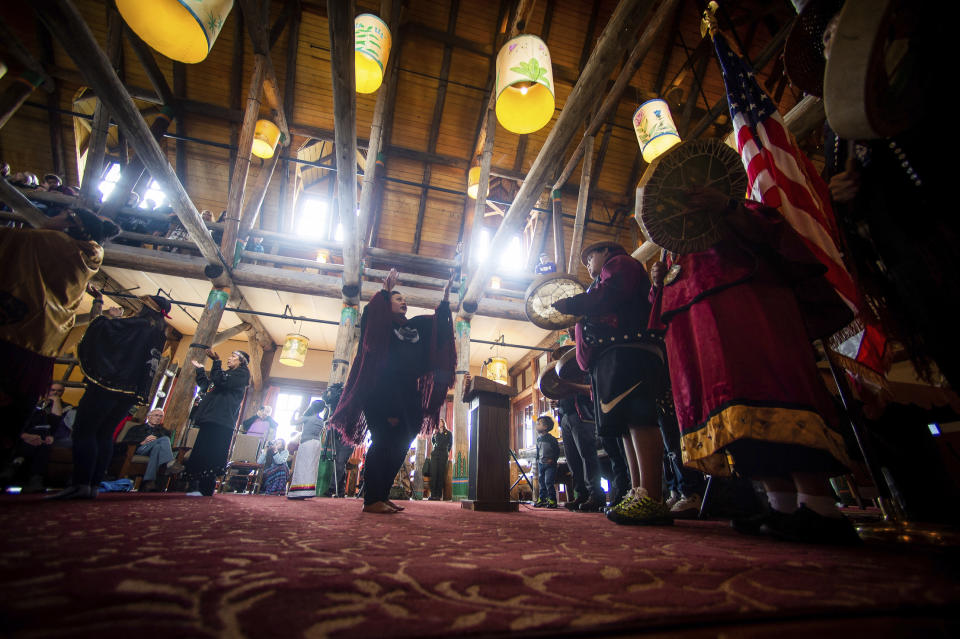 Members of the Nisqually Canoe Family perform during a grand opening event for the renovated Paradise Inn at Mount Rainier National Park in Paradise, Wash., on Friday, May 17, 2019. The Paradise Inn recently completed the second and final phase of a renovation project. (Joshua Bessex/The News Tribune via AP)
