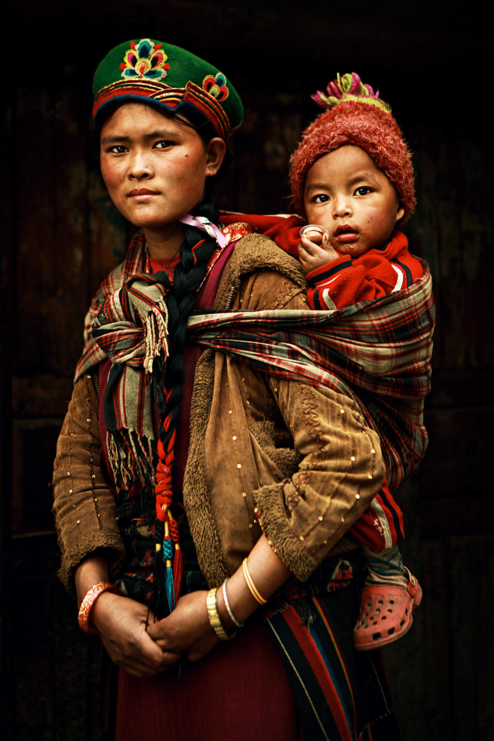 A baby clings onto his mother's back in 'Madonna from Nepal' (Artem Zhushman)