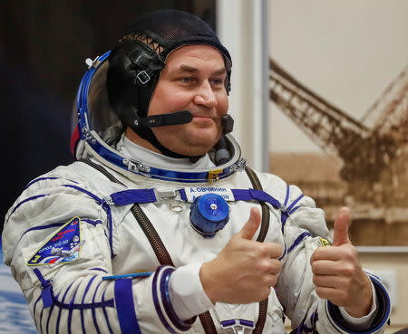 The International Space Station (ISS) crew member cosmonaut Alexey Ovchinin of Russia gestures after donning a space suit shortly before a launch at the Baikonur Cosmodrome, Kazakhstan October 11, 2018. REUTERS/Shamil Zhumatov