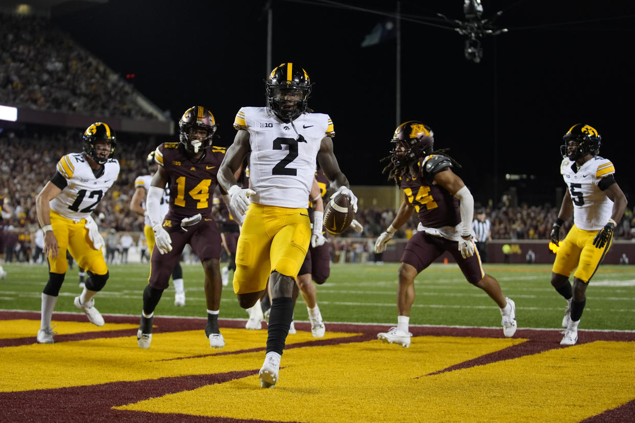 Iowa running back Kaleb Johnson (2) scores a 15-yard rushing touchdown during the second half of an NCAA college football game against Minnesota, Saturday, Sept. 21, 2024, in Minneapolis. (AP Photo/Abbie Parr)