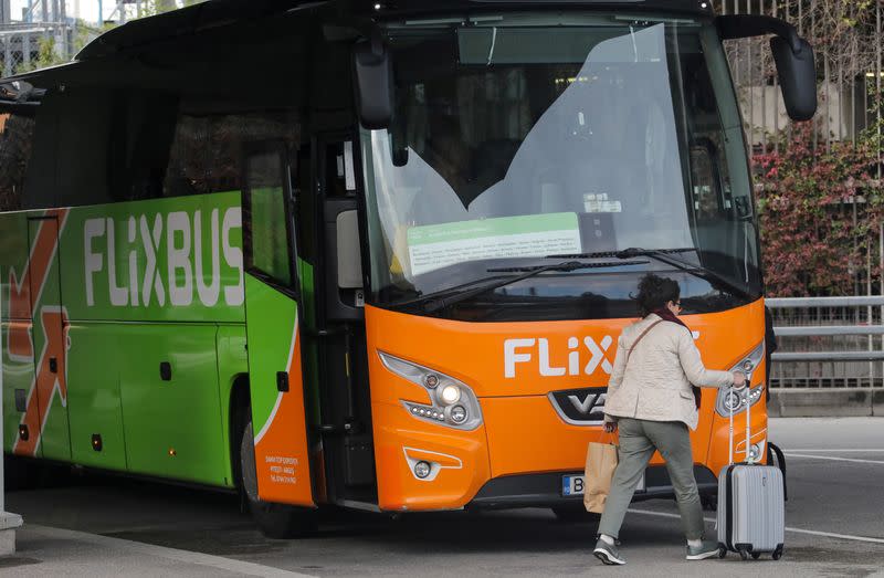 FILE PHOTO: A passenger walks by a FlixBus bus at Nice international airport