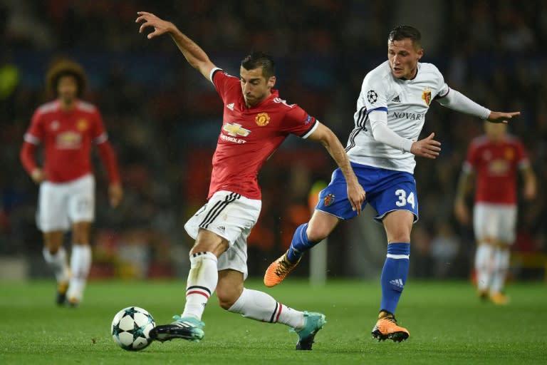 Manchester United's Henrikh Mkhitaryan (L) fights for the ball with Basel's Taulant Xhaka during their UEFA Champions League Group A match, in Manchester, on September 12, 2017