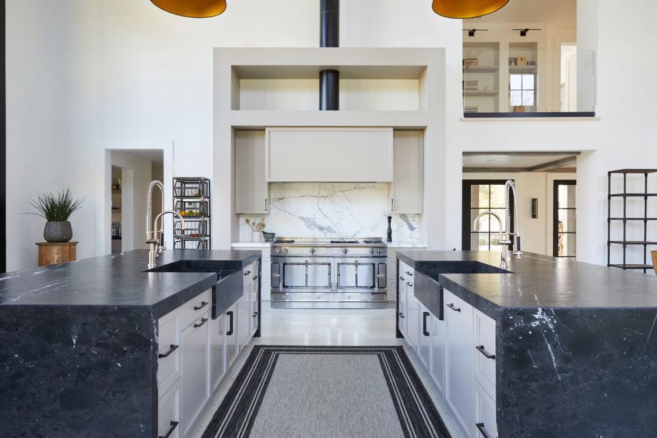 a kitchen with black counter tops