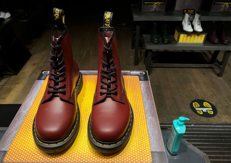 FILE PHOTO: A pair of Dr. Martens boots is seen through the window of a Dr Martens store in London