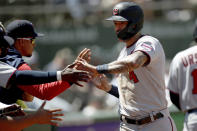 Minnesota Twins' Carlos Correa (4) is congratulated after scoring in the sixth inning of a baseball game against the Oakland Athletics in Oakland, Calif., on Wednesday, May 18, 2022. (AP Photo/Scot Tucker)