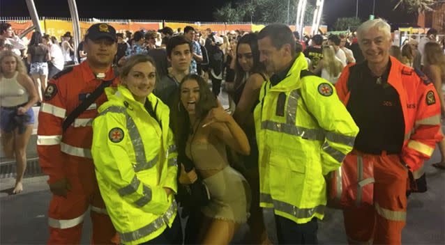 Ambulance paramedics pose with two school leavers. Source: Twitter