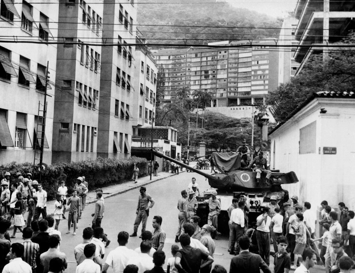 <span>Brazilian army tanks stand in front of Laranjeiras Palace, on 1 April 1964 in Rio de Janeiro during the military putsch that led to the overthrow of President João Goulart by members of the Brazilian armed forces.</span><span>Photograph: AFP/Getty Images</span>