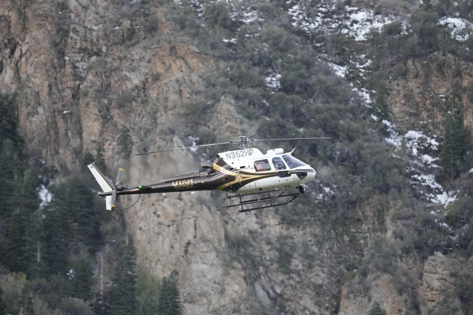 A Utah Department of Public Safety helicopter carries recovery crews from a staging area, Friday, May 10, 2024, in Sandy, Utah. Two backcountry skiers were killed and one was rescued after an avalanche Thursday, May 9, 2024, in the mountains outside of Salt Lake City. (AP Photo/Rick Bowmer)