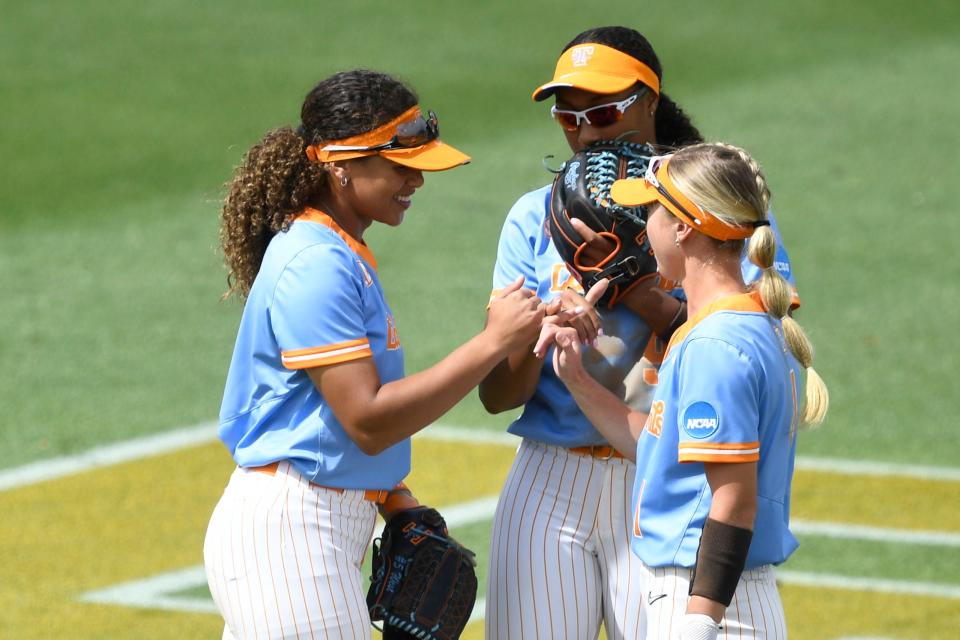 Tennessee's Rylie West (5), Kiki Milloy (9), and Katie Taylor (1) lock pinkies before the start of the inning during the NCAA softball super regional against Texas in Knoxville,Tenn. on Saturday, May 27, 2023. 