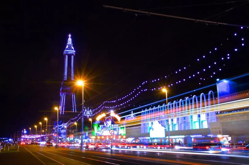 The Famous Blackpool Tower and lights along the stretch of promenade known as the Golden Mile in Blackpool