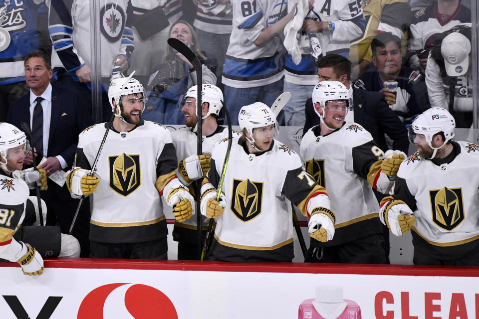 The Vegas Golden Knights bench celebrates their fourth goal against the Winnipeg Jets during the third period in Game 4 of an NHL Stanley Cup first-round hockey playoff series in Winnipeg, Manitoba, Monday, April 24, 2023. (Fred Greenslade/The Canadian Press via AP)