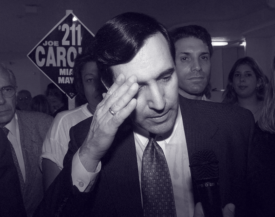 After losing a November 1997 runoff to Xavier Suarez, father of the current mayor, Joe Carollo speaks to reporters while surrounded by somber supporters at his campaign headquarters.