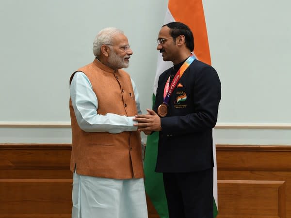 Prime Minister Narendra Modi congratulating Singhraj Adhana