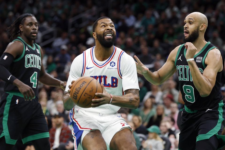 Philadelphia 76ers' Marcus Morris Sr. looks to shoot, between Boston Celtics' Jrue Holiday (4) and Derrick White (9) during the first half of an NBA basketball game Friday, Dec. 1, 2023, in Boston. (AP Photo/Michael Dwyer)