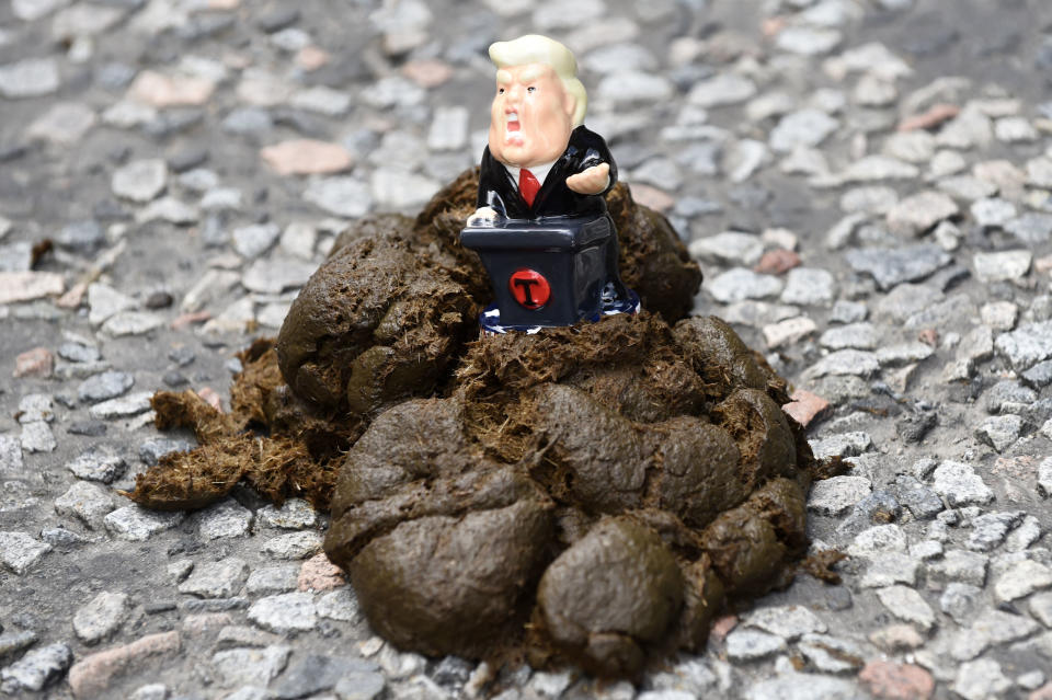 <p>A miniature statue of President Trump is placed atop a pile of dung as Scotland United Against Trump demonstrators gather at the Scottish Parliament in Edinburgh before marching through the city to a “Carnival of Resistance” to protest the visit of Trump to the U.K. (Photo: Lesley Martin/PA Images via Getty Images) </p>