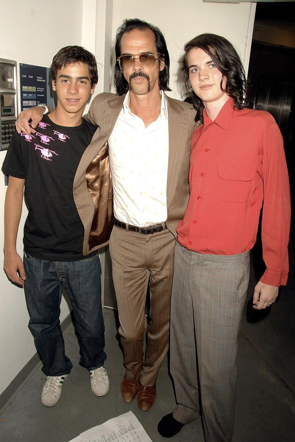 Nick Cave with his sons Luke and Jefro Cave (R) attend the fashion show at Portobello Film Festival curated by Bella Freud with clothes from Portobello Market, at Westbourne Studios on August 3, 2006 in London, England