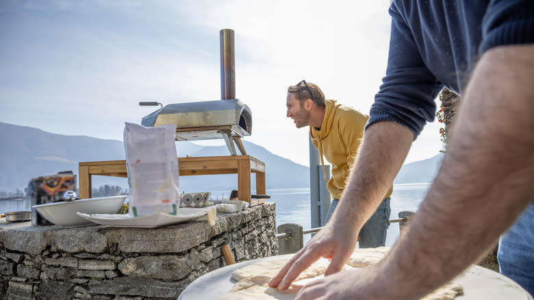 person looking at pizza oven