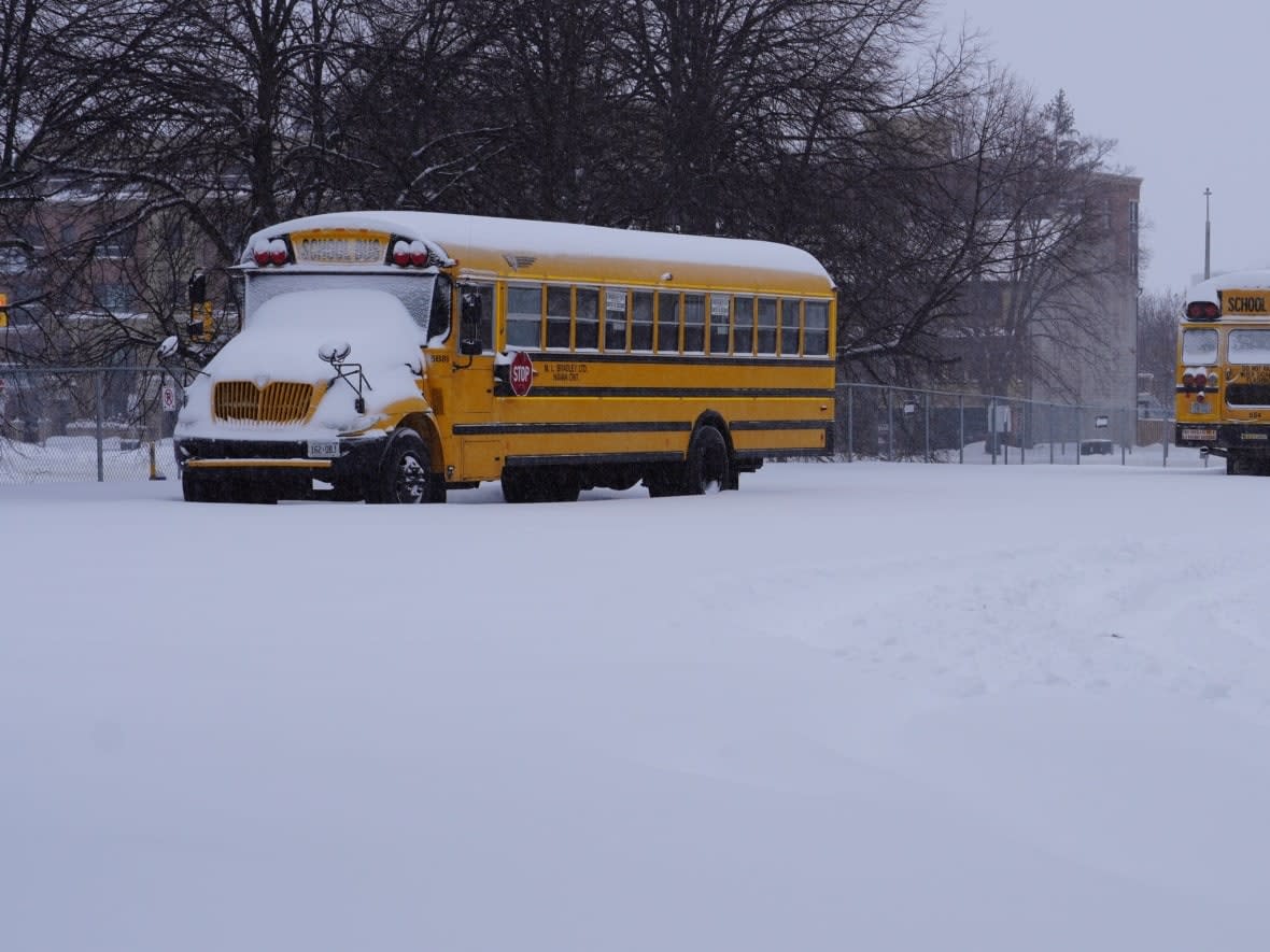 School buses sit outside École secondaire publique De la Salle in Ottawa's central Lowertown neighbourhood Jan. 17, 2022. Buses were not running that day because of a snowstorm. (Simon Lasalle/CBC - image credit)