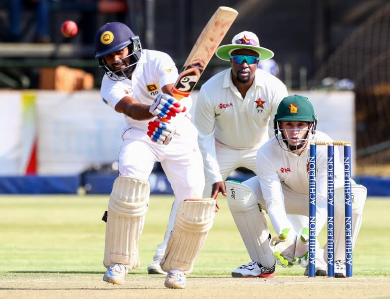 Sri Lanka batsman Kaushal Silva hits the ball as wicketkeeper Peter Moor and Tinotenda Mawoyo look on during the first cricket Test match between Sri Lanka and hosts Zimbabwe at the Harare Sports Club, on October 29, 2016