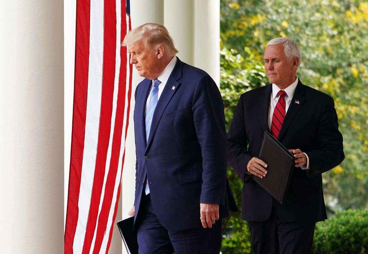 President Donald Trump and Vice President Mike Pence arrive in the Rose Garden to speak on COVID-19 testing at the White House in Washington on Sept. 28, 2020.