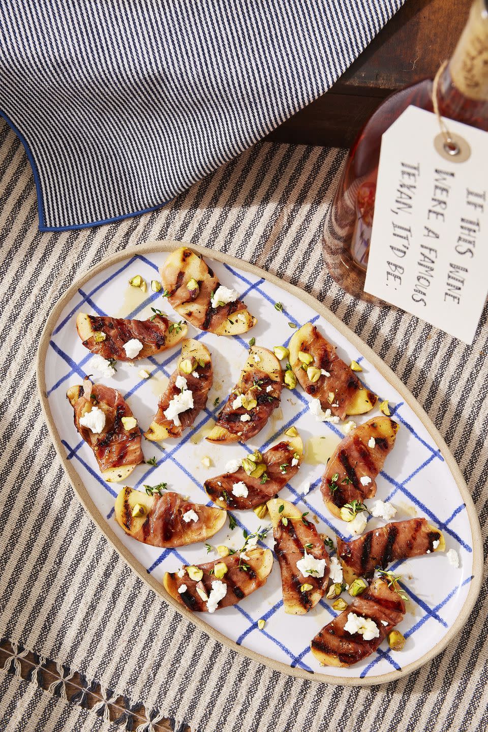 grilled apples with prosciutto and honey on an oval serving tray