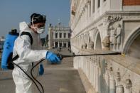 A worker sanitises Ponte della Paglia bridge on St. Mark's square as a measure to fight against the coronavirus contagion in Venice