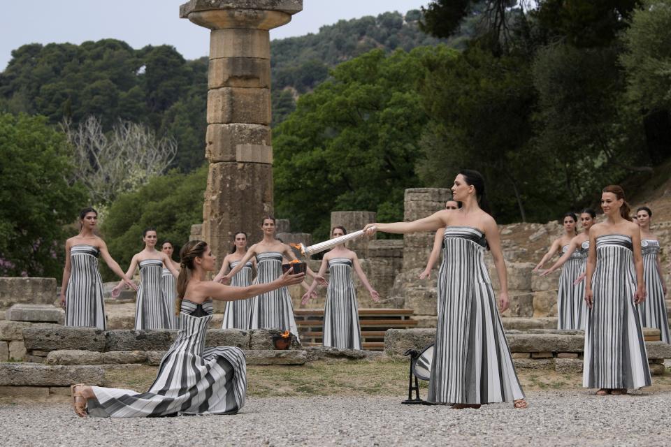 Performers take part in the official ceremony of the flame lighting for the Paris Olympics, at the Ancient Olympia site, Greece, Tuesday, April 16, 2024. The flame will be carried through Greece for 11 days before being handed over to Paris organizers on April 26. (AP Photo/Thanassis Stavrakis)