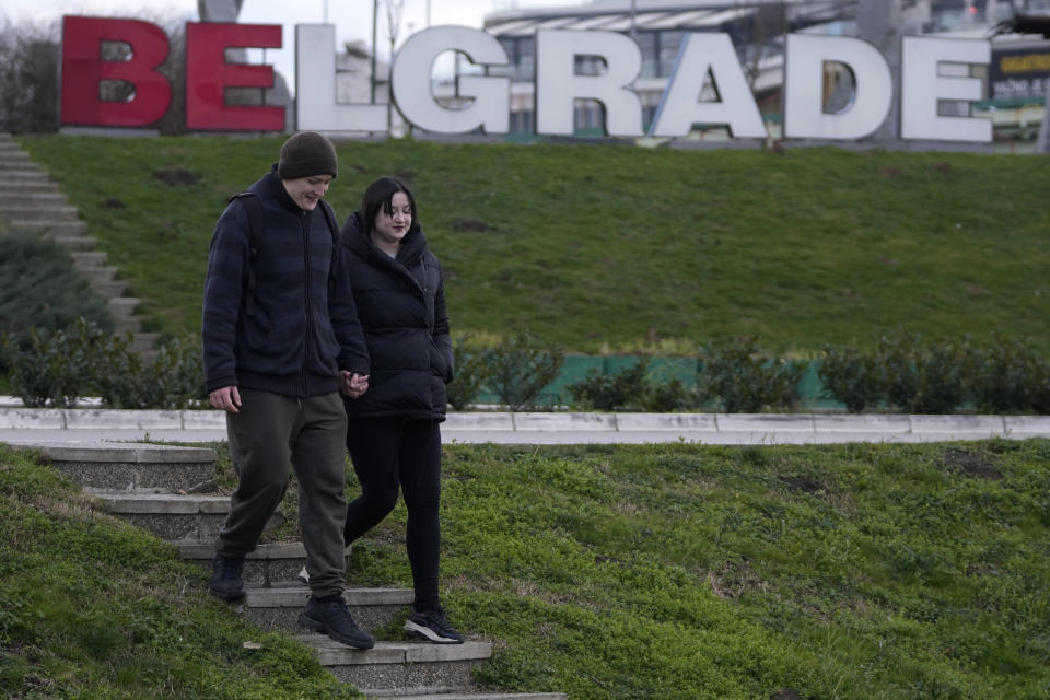 Mariia Vyhivska from Ukraine, right, and Iurii Kurochkin, from Russia, walk on the banks of the Ada Ciganlija Lake, in Belgrade, Serbia, Sunday, Feb. 5, 2023. Vyhivska and Kurochkin fell in love before Russia invaded Ukraine, while playing an online video game. To get together, they had to leave their homes and defy hatred generated by war. An estimated 200,000 Russians and some 20,000 Ukrainians have come to Serbia in the past year. (AP Photo/Darko Vojinovic)