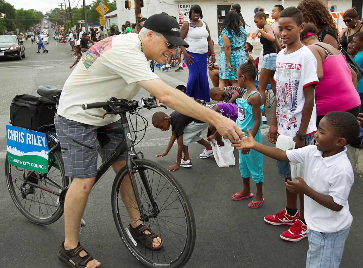 Austin Council member Chris Riley hands out candy at the intersection of E. 12st St. and Chicon Street. The Juneteenth Parade was held Saturday morning June 15, 2013 through the streets of east Austin where thousands came out of their neighborhoods to take in the sights and sounds of the annual celebration marking the abolition of slavery in the state of Texas in 1865.