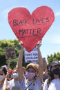 A protester holds a sign during a protest in Los Angeles, Saturday, May 30, 2020. Demonstrators took to the streets of Los Angeles to protest the death of George Floyd, a black man who was killed in police custody in Minneapolis on May 25. (AP Photo/Ringo H.W. Chiu)