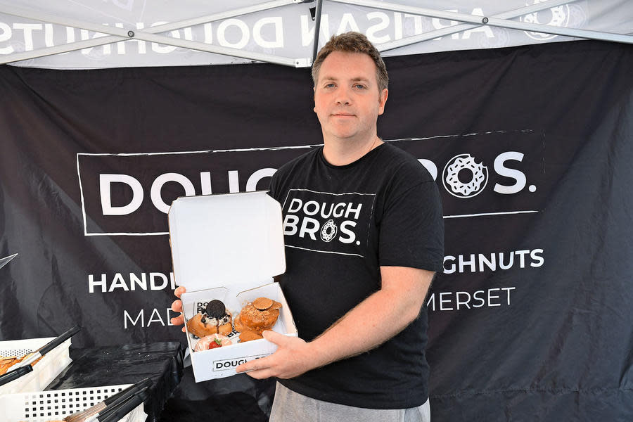 Ricky of Dough Bros Taunton holds up a box of donuts