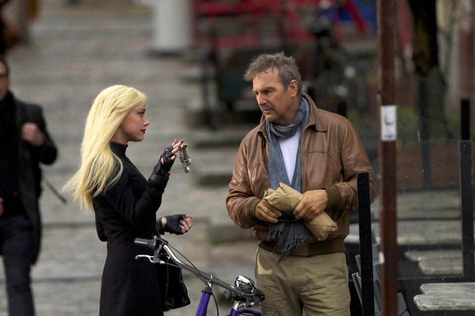 This image released by Relativity Media shows Amber Heard, left, and Kevin Costner in a scene from "3 Days to Kill." (AP Photo/Relativity Media, Julian Torres)