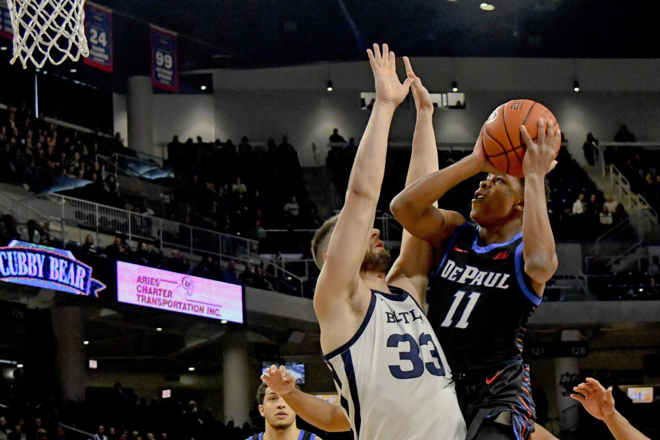 over guard Charlie Moore (11) shoots past Butler forward Bryce Golden (33) during the first half of an NCAA college basketball game Saturday, Jan. 18, 2020, in Chicago. (AP Photo/Matt Marton)