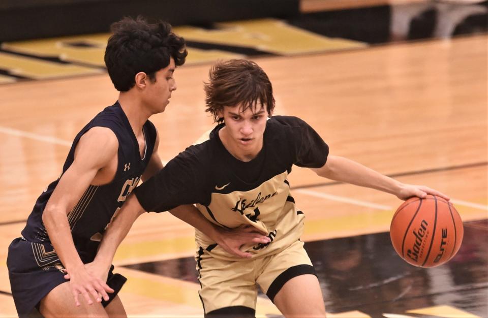 Abilene High's Brooks Reese, right, brings the ball up court as an El Paso Coronado player defends.