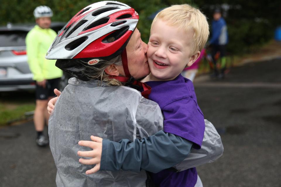 Georgia Dangel, of Stow, gives her son Lucas, 5, a kiss before the start of the 25th Annual Cystic Fibrosis Foundation Cycle For Life in Holliston, Oct. 1, 2022.