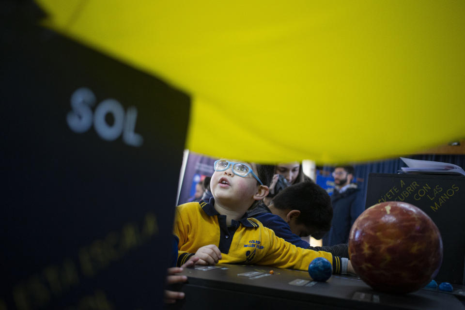 Blind school children take part in a sensorial experience with tools created by NASA and Edinburgh University to experience an eclipse, during an event in the Helen Keller school in Santiago, Chile, Tuesday, June 25, 2019. The event comes exactly one week ahead of a total solar eclipse which is set to be fully visible in various South American countries, including Chile. (AP Photo/Esteban Felix)