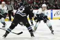 Seattle Kraken left wing Brandon Tanev (13) skates with the puck against Washington Capitals defenseman Matt Irwin (52) during the second period of an NHL hockey game Friday, Dec. 9, 2022, in Washington. (AP Photo/Nick Wass)