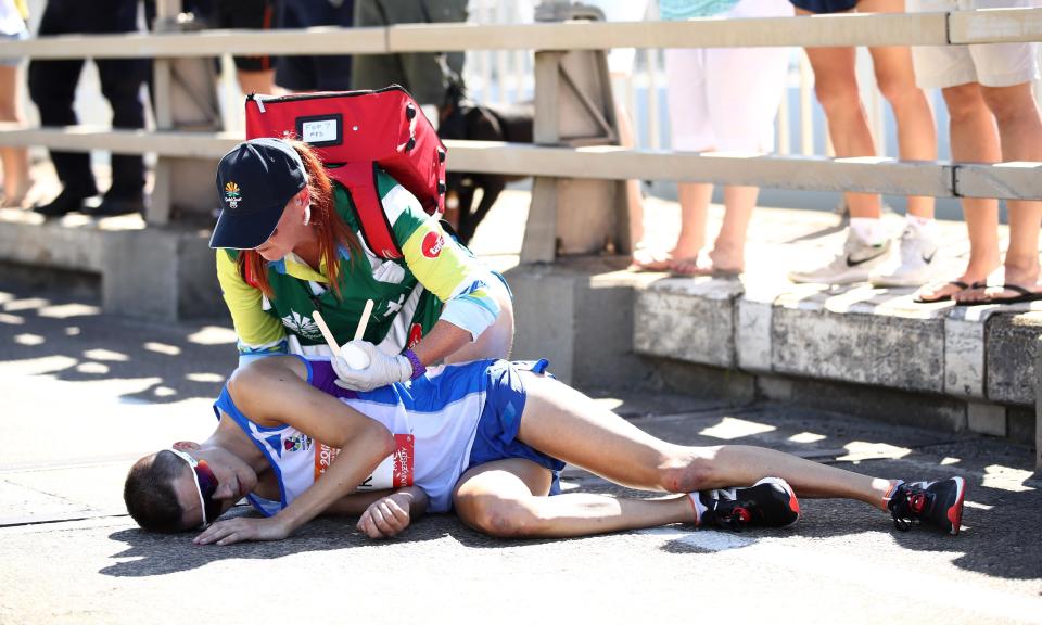 Callum Hawkins of Scotland receives medical assistance after collapsing during the men’s marathon on day 11 of the Gold Coast 2018 Commonwealth Games.